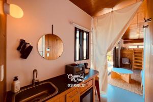 a kitchen with a sink and a mirror at OceansideRanch Miyazaki in Miyazaki
