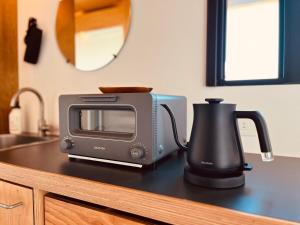 a toaster sitting on top of a counter next to a microwave at OceansideRanch Miyazaki in Miyazaki