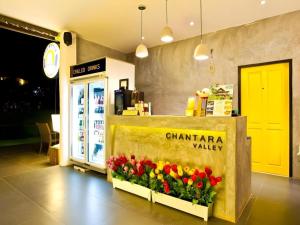 a chianttera valley store with flowers on the counter at Chantara Valley Resort in Ban Sap Bon +222 photos