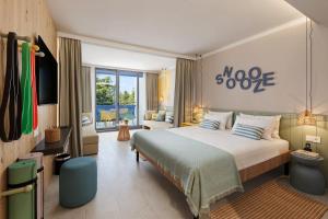 a bedroom with a large bed and a television at Sunny Porec by Valamar in Poreč