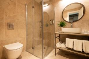a bathroom with a shower and a toilet and a sink at Hotel Beit Shmuel in Jerusalem +37 photos