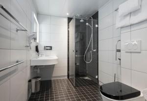 a bathroom with a shower, sink, and toilet at Thon Hotel Stavanger in Stavanger