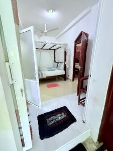 a room with a bedroom with a bed and a mirror at Tiny Royal Palace in Unawatuna