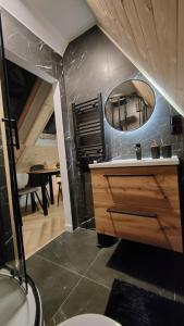 a bathroom with a sink and a mirror at Studio Góralskie Klimaty z widokiem na Góry, Kominek, Parking, Jacuzzi, Sauna in Biały Dunajec