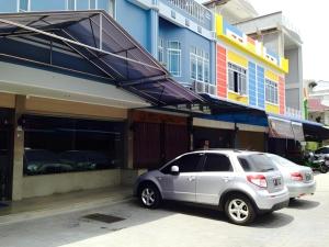 a silver car parked in front of a building at H3 Hotel in Tanjung Balai Karimun