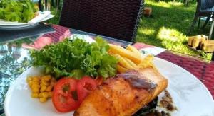 a plate of food with meat and vegetables on a table at Montana Cotswolds Resort in Ban Kom