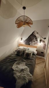 a bedroom with a large bed with a mountain mural on the wall at Studio Góralskie Klimaty z widokiem na Góry, Kominek, Parking, Jacuzzi, Sauna in Biały Dunajec +69 photos
