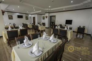 a banquet hall with tables and chairs with napkins at The Mou Hotel in Phnom Penh