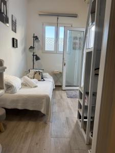 a bedroom with a bed and a glass door at New Garden in Mairena del Aljarafe
