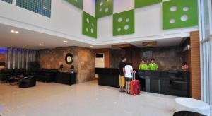a group of people standing in a lobby with luggage at Tanzeno Hotel in Ban Na Kai
