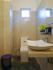 a bathroom with a sink and a toilet at Mountain Relax Inn in Weligama