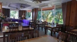 a restaurant with tables and chairs in a room at Sirimathani Hotel in Ban Hua Fai +62 photos