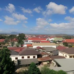 a group of buildings with red roofs in a city at Favanhmai Hotel in Phonsavan