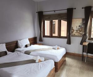 Ένα ή περισσότερα κρεβάτια σε δωμάτιο στο Baan Home Resort