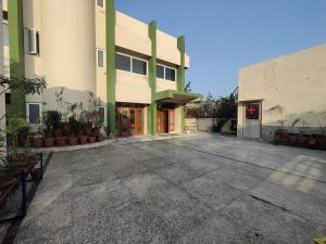 an empty parking lot in front of a building at Orchid Stays in Ajmer