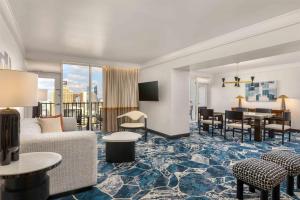 a living room with a couch and a table at Hilton Palacio del Rio in San Antonio