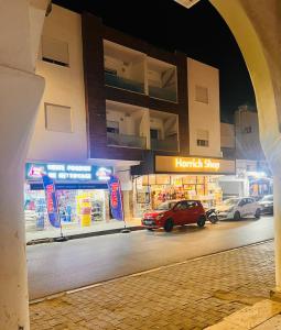 a hotel shop with a car parked in front of it at RESIDENCE FEDI un salon et deux chambres in Monastir