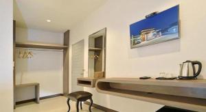 a room with a counter and a chair in it at The Rich Resort in Krabi town