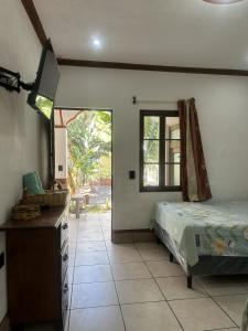 Hospedaje Nicolas في سان خوان لاجونا: غرفة نوم بسرير وخزانة ونافذة