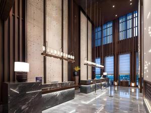 a lobby of a building with large windows at Hampton by Hilton Nanhai Haikou in Haikou