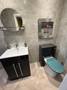 a bathroom with a sink and a toilet and a mirror at Cleveleys Town Centre in Blackpool +6 photos