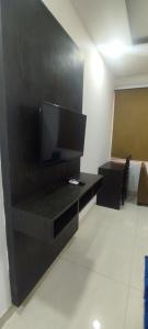 a living room with a flat screen tv on a wall at Glory prime suits in New Delhi