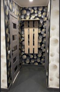 a room with a door and a wall of wine bottles at Family in Mukacheve