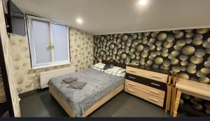 a bedroom with a bed and a wall of logs at Family in Mukacheve