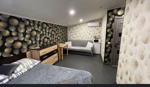 a room with a bed and a couch and a wall with barrels at Family in Mukacheve