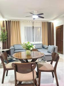 a living room with a table and a couch at Los Glomos RestHub in Los Baños +77 photos