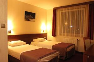 Posteľ alebo postele v izbe v ubytovaní Hotel Arena Expo