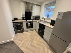 a kitchen with a washer and dryer in it at Cleveleys Town Centre in Blackpool