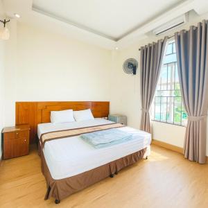 a bedroom with a bed and a large window at Hương Sen Hotel Bac Giang in Bắc Giang