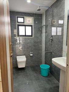 a bathroom with a toilet and a sink at ClubGreens in Jorhat +20 photos