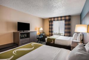 a hotel room with two beds and a flat screen tv at Quality Inn & Suites Missoula Westside in Missoula +45 photos