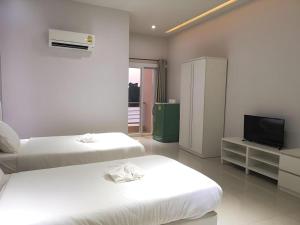 a hotel room with two beds and a television at River Residence Saraburi Hotel in Ban Kok (1) +46 photos