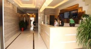 two women sitting at a counter in a restaurant at GreenTree Inn Beijing Shunyi Fengbo Metro Station in Qianfengbo