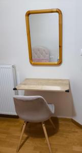 a desk with a mirror and a chair in a room at Η πέρλα της λίμνης/ The lake's pearl in Ioannina