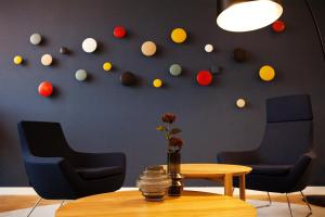 a room with a table and chairs and a wall with balls at Holiday Inn Express - Kaiserslautern by IHG in Kaiserslautern