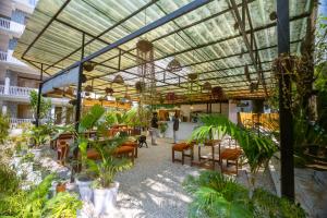 a building with a patio with chairs and plants at TLO - The Life Outdoor, Bir Billing in Bīr