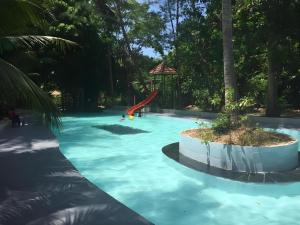 a swimming pool with a slide in the middle at Ranong Resort & Laguna in Ban Samnak +51 photos