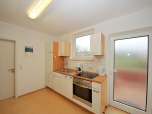 a kitchen with a sink and a stove top oven at Haus Nixe Stranddüne in Juist