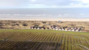 an aerial view of a farm and the ocean at ENA Ferien Strandkiste in Juist +4 photos