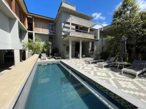 a swimming pool in front of a house at The gallery luxury one bedroom apartment unit 101 in Knysna