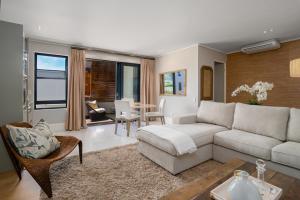 a living room with a couch and a table at The gallery luxury one bedroom apartment unit 101 in Knysna