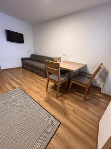 a living room with a table and a couch at Höller's Bergleben in Kleinarl
