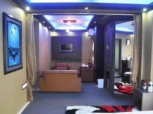 a room with a living room with a couch at Grand Dhaka Hotel in Dhaka