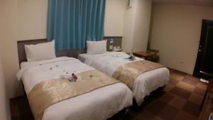 Postel nebo postele na pokoji v ubytování Chang Ti Metropolis Commercial Hotel