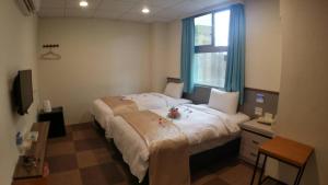 Postel nebo postele na pokoji v ubytování Chang Ti Metropolis Commercial Hotel