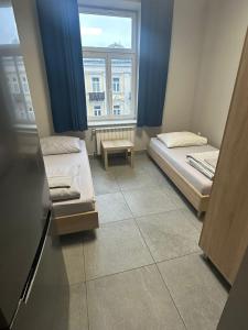 a small room with two beds and a window at StarBal in Radom